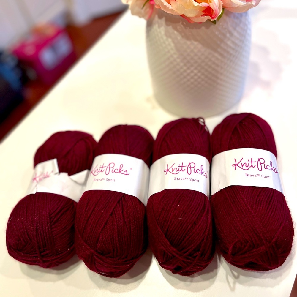Four knit picks Brava sport weight yarn. Color wine.